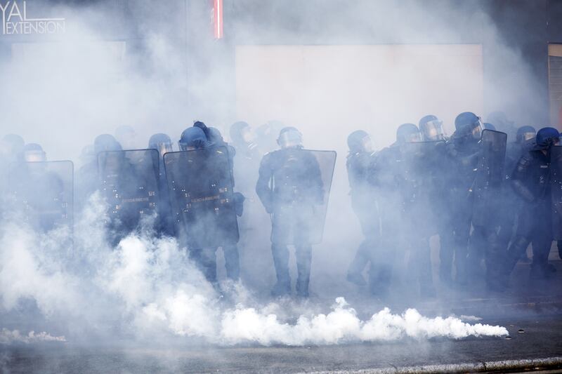 Riot police are surrounded by tear gas during clashes with protesters. EPA
