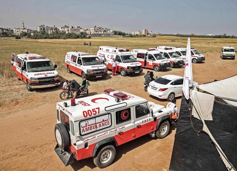 Palestinian emergency vehicles parked near the Israel-Gaza border before the protest. AFP