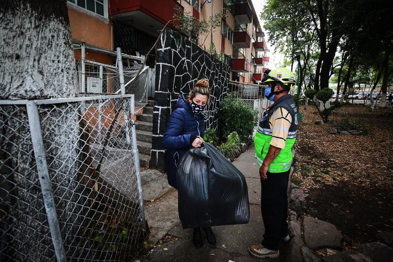 A resident takes her belongings from her apartment. Getty Images