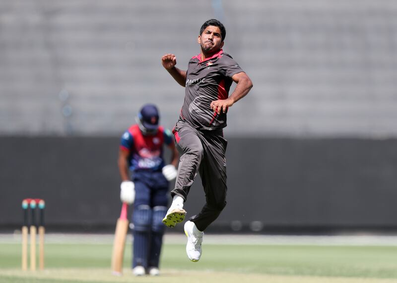 UAE's Junaid Siddique takes the wicket of Nepal's Aasif Sheikh. 