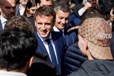 Gerald Darmanin, behind French President Emmanuel Macron, whom he is tipped to succeed in 2027, at a campaign stop in April. AFP 