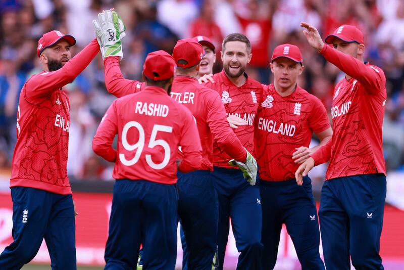 England bowler Chris Woakes, centre, is congratulated by teammates after talking the wicket of India opener KL Rahul for five. AP