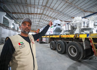 Abdulaziz Al Kadhi, an official with the Emirates Red Crescent, supervises a delivery destined for Gaza. Victor Besa / The National