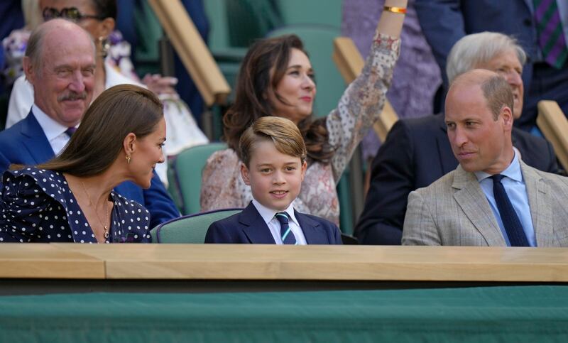 Britain's Prince William, his wife Kate, Duchess of Cambridge and their son Prince George sit in the Royal box for the final of the men's tennis singles at Wimbledon. AP