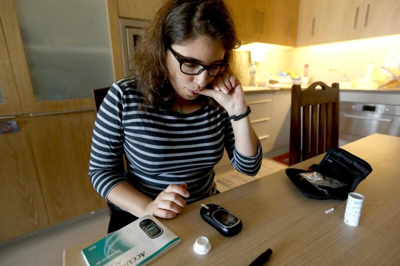 Sara Taher, a pre-diabetic checks her sugar levels. Sammy Dallal / The National
