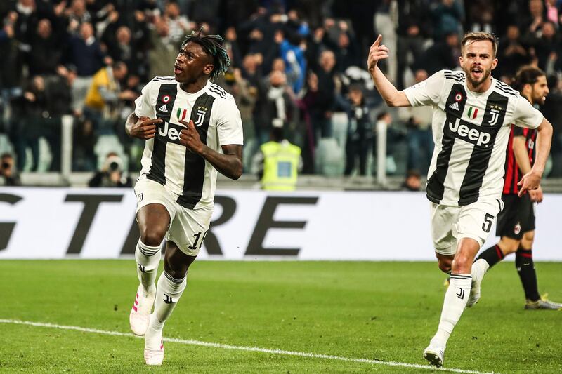 Juventus' Italian forward Moise Kean (L) celebrates with Juventus' Bosnian midfielder Miralem Pjanic after scoring during the Italian Serie A football match Juventus vs AC Milan on April 6, 2019 at the Juventus stadium in Turin. / AFP / Isabella BONOTTO
