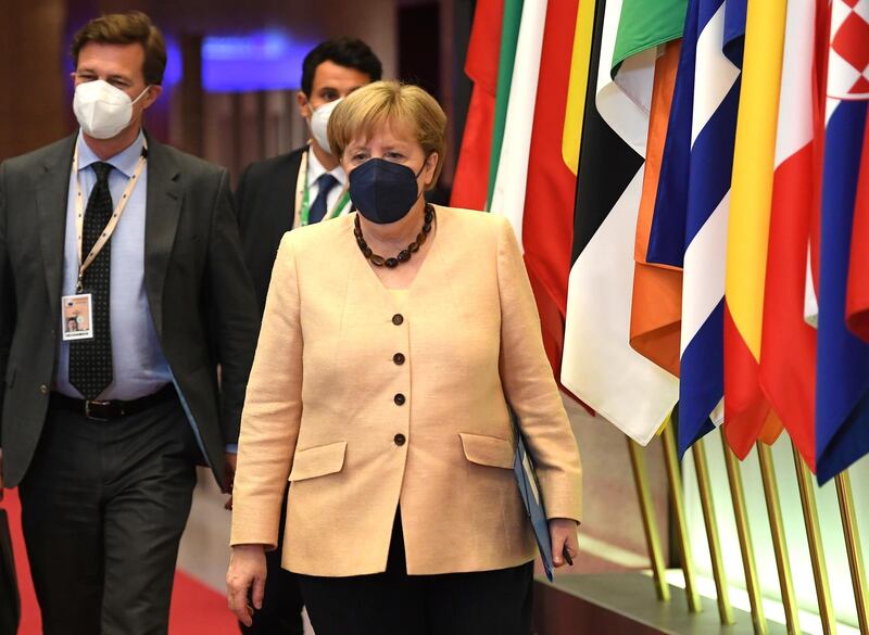 Angela Merkel leaves at the end of an EU summit at the European Council building in Brussels. AP Photo