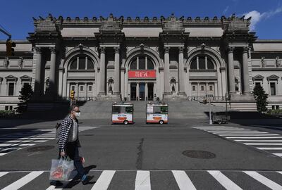 (FILES) In this file photo taken on May 4, 2020 a man wearing a facemask walks past the Metropolitan Museum of Art "The Met" in New York City.  New York's Metropolitan Museum plans to reopen in mid-August, "or maybe a few weeks later," with reduced hours and no tours to maintain social distancing, the museum said on May 19, 2020. / AFP / Angela Weiss
