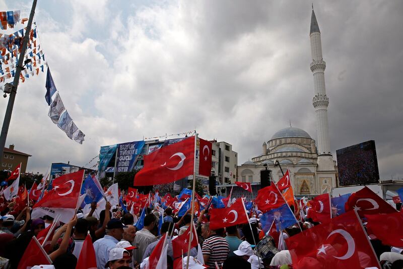 People wave Turkish flags during an election rally of Turkey's President Recep Tayyip Erdogan and his ruling Justice and Development Party, or AKP, in Istanbul, Turkey, on June 23, 2018. Lefteris Pitarakis / AP Photo