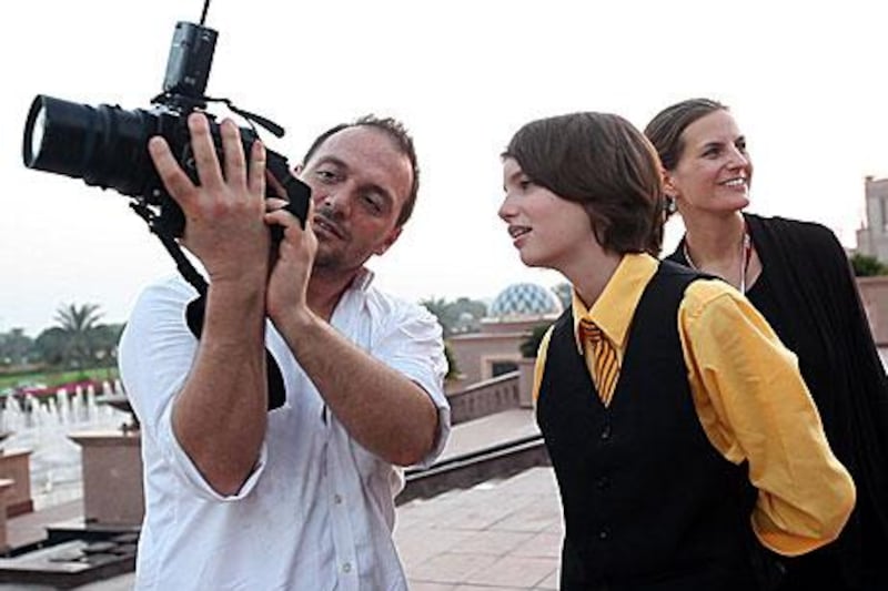 Fabrice Dall’Anese shows Kodi Smit-McPhee, an Australian actor, a photo during the Abu Dhabi Film Festival.