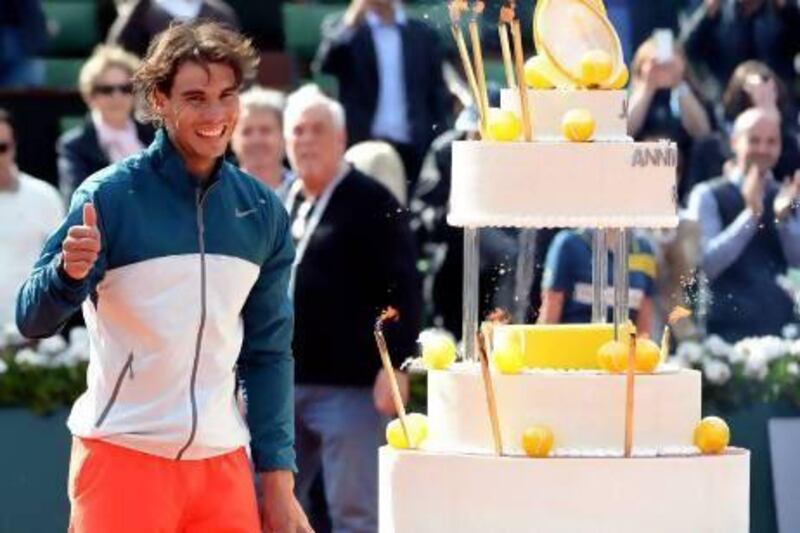 The crowd at Roland Garros sang 'Happy Birthday' aloud as Rafael Nadal received a cake on court on his 27th birthday. Caroline Blumberg / EPA