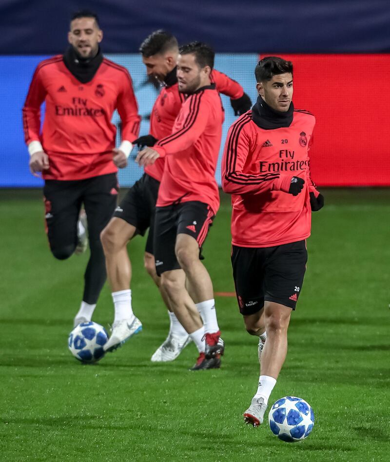 Marco Asensio, right, and teammates takes part in a training session. EPA