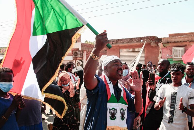 A demonstrator waves a Sudanese flag at a rally in northern Khartoum.