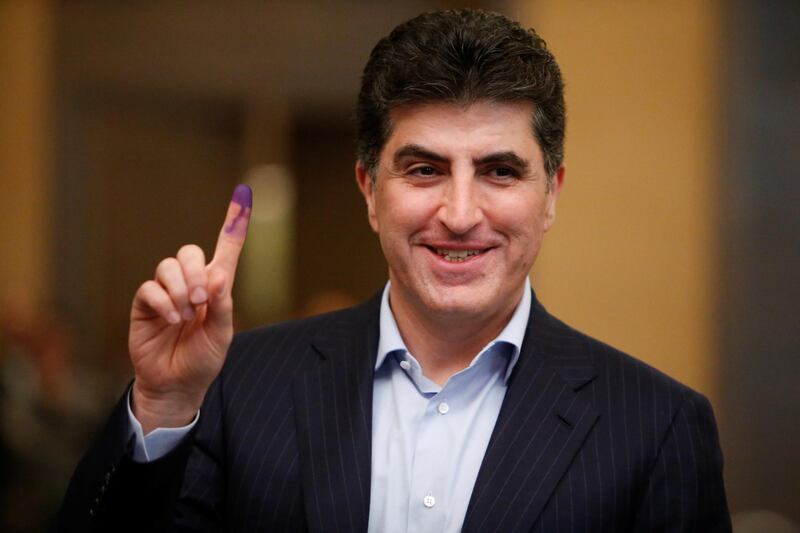 Kurdistan Regional Government Prime Minister Nechirvan Barzani shows his ink-stained finger after casting his vote at a polling station during the parliamentary election in Erbil. Azad Lashkari / Reuters