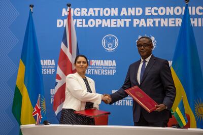 Britain's Home Secretary, Priti Patel, shakes hands with Rwanda's Minister of Foreign Affairs, Vincent Biruta , after signing the asylum-processing deal in Kigali, Rwanda, on April 14. AP