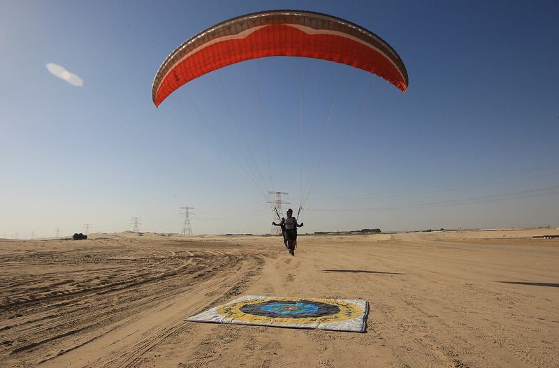 ABU DHABI - UNITED ARAB EMIRATES - 16FEB2013 - Marazmizal Omar paraglider makes a spot landing from a 600m-high manmade hill at Al Wathba area outside Abu Dhabi. Ravindranath K / The National