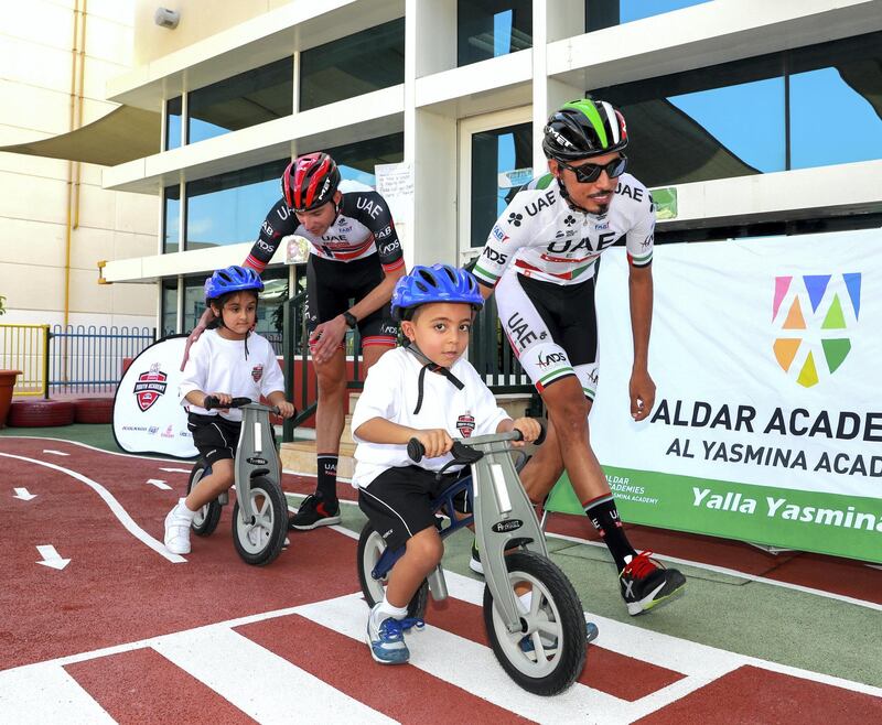 Abu Dhabi, U.A.E., October 29, 2018.  UAE Cycling Team Emirates visit the Al Yasmina School to give a brief cycling workshop. -- Yousif Mirza and Vegard Stake Laegen teach some todlers how to bike on a play track.
Victor Besa / The National
Section:  SP
Reporter:  Amith Passela