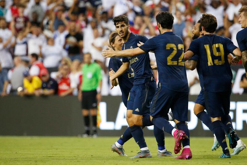 Real Madrid midfielder Marco Asensio  celebrates with teammates after scoring. Reuters