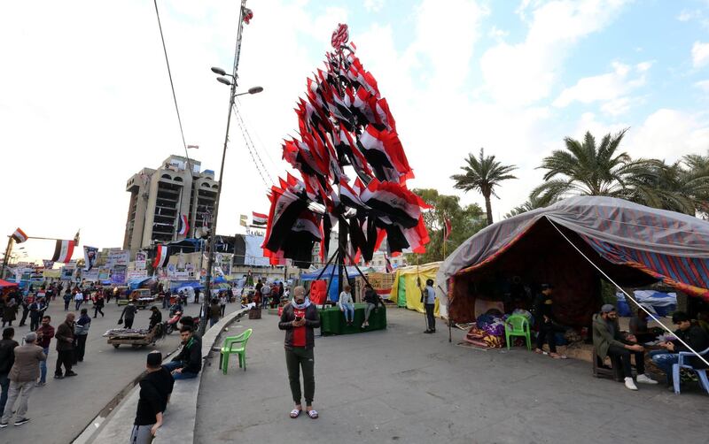 A Christmas tree is decorated with national flags and the pictures of protesters who were killed in clashes at Tahrir Square. EPA