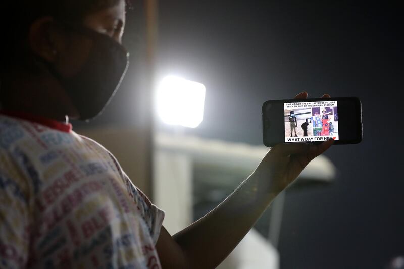 Sharjah, United Arab Emirates - Reporter: Paul Radley. Sport. Paul 7 and Mary 13 (in photo). Paul got a ball the other day hit by Royal Challengers of Bangalore player AB de Villiers featured on RCB's social media. People who wait outside Sharjah cricket stadium to try and get ball hit from the IPL. Monday, October 26th, 2020. Sharjah. Chris Whiteoak / The National