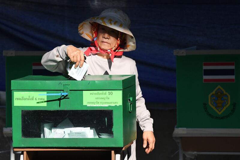 A woman casts her ballot at a polling station in Bangkok. AFP