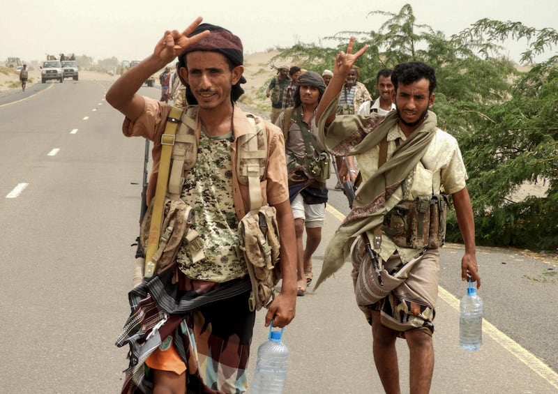 Yemeni pro-government forces flash the victory gesture as they arrive in al-Durayhimi district, about nine kilometres south of Hodeidah international airport on June 13, 2018. Yemeni forces backed by the Saudi-led coalition launched an offensive on June 13 to retake the rebel-held Red Sea port city of Hodeida, pressing toward the airport south of the city.
The port serves as the entry point for 70 percent of the impoverished country's imports as it teeters on the brink of famine. / AFP / NABIL HASSAN
