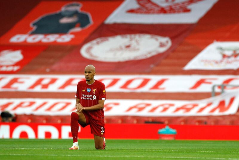 LIVERPOOL, ENGLAND - JULY 22: Fabinho of Liverpool takes a knee in support of the Black Lives Matter movement prior to the Premier League match between Liverpool FC and Chelsea FC at Anfield on July 22, 2020 in Liverpool, England. Football Stadiums around Europe remain empty due to the Coronavirus Pandemic as Government social distancing laws prohibit fans inside venues resulting in all fixtures being played behind closed doors. (Photo by Phil Noble/Pool via Getty Images)