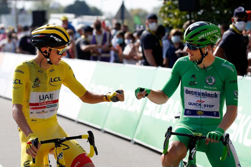 Slovenian rider Tadej Pogacar (L) of UAE-Team Emirates wearing the overall leader's yellow jersey and Irish rider Sam Bennett  (R) of Deceuninck Quick-Step team wearing the best sprinter green jersey greet each other before the start of the 21th stage of the Tour de France cycling race over 122 km from Mantes la Jolie to Paris, France. EPA