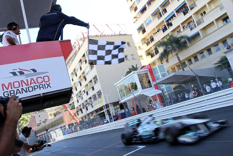 Mercedes'  German driver Nico Rosberg crosses the finish line at the Circuit de Monaco in Monte Carlo on May 26, 2013 after the Monaco Formula One Grand Prix.    AFP PHOTO / JEAN-CHRISTOPHE MAGNENET
 *** Local Caption ***  202980-01-08.jpg