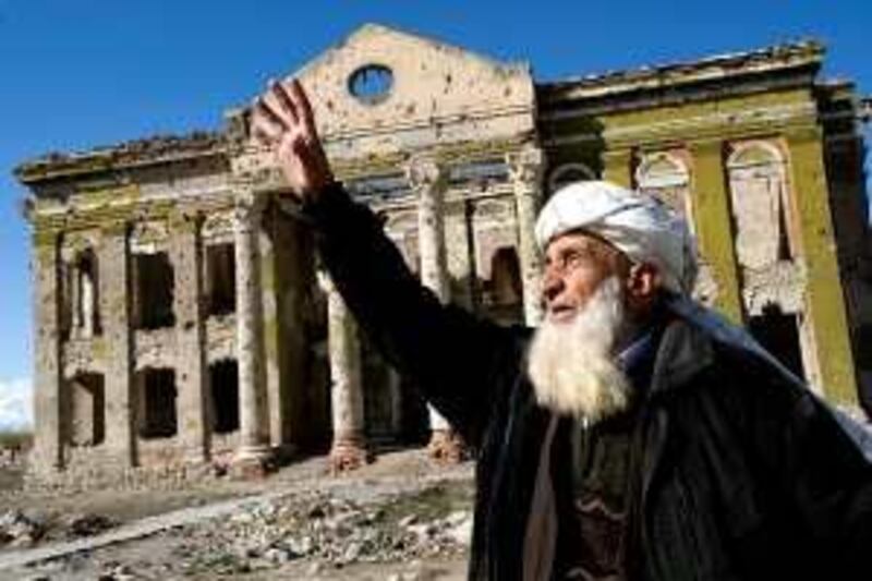 An elderly Afghan gestures as he speaks of God as he makes his way past one of Kabul's many buildings destroyed in fighting between rival militias in the mid-1990s. Residents of the city see little hope of a peaceful end to the latest conflict that is tearing their country apart.

Chris Sands/The National *** Local Caption ***  reachingforgod.jpg