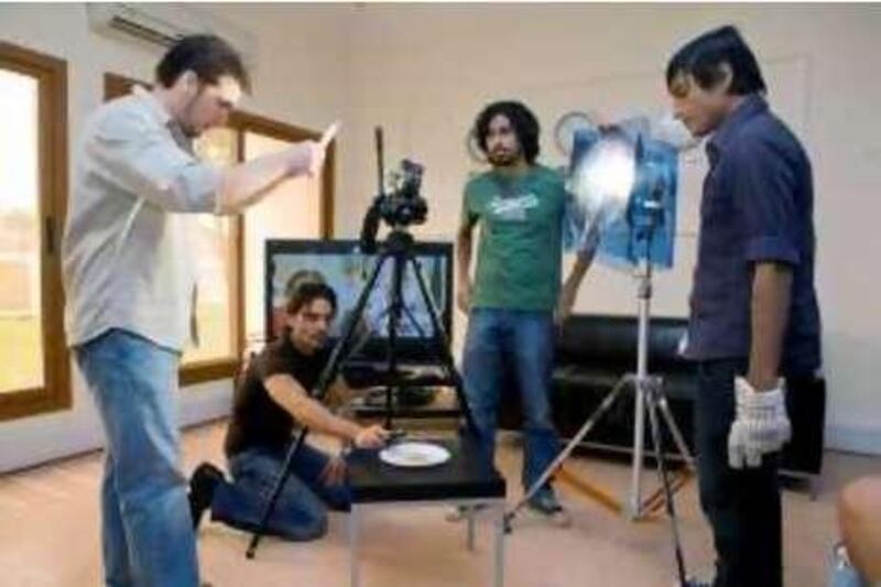 Abu Dhabi - UAE - September 18, 2008 - Students set up lights to shoot a cookie for their short film, 'The Cookie.'   New York Film Acadamy students set-up, shoot, and direct their own films in the first week of classes. (Nicole Hill / The National)
 *** Local Caption ***  NHNewYorkFilm12.jpg