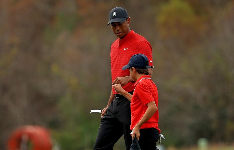 Tiger Woods and son Charlie fist bump on the 15th hole during the final round of the PNC Championship at the Ritz Carlton Golf Club. AFP