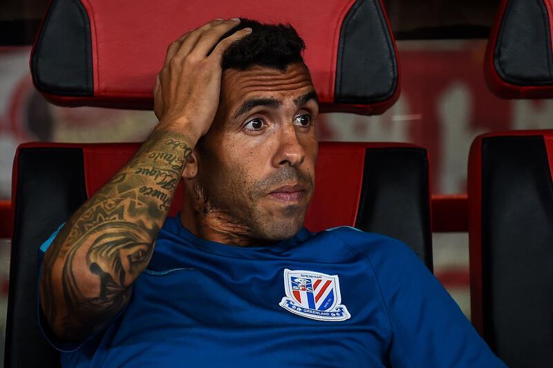 (FILES) This file picture taken on September 16, 2017 shows Shanghai Shenhua's Carlos Tevez looking on during the 2017 Chinese Super League football match between Shanghai East Asia (SIPG) FC and Shanghai Shenhua in Shanghai.
Carlos Tevez looks poised to end his miserable 12-month spell in China with the Argentine former international in talks with his club Shanghai Shenhua to terminate his mammoth contract. A Shenhua spokesman told AFP on January 5, 2018 that the club was in discussions with the former Manchester United, Manchester City and Juventus striker to end his contract. / AFP PHOTO / Chandan KHANNA /  - China OUT
