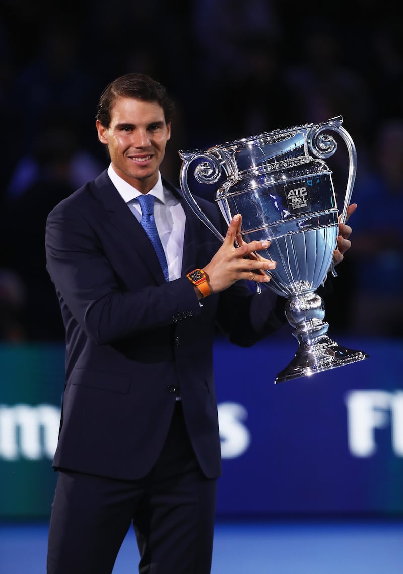 LONDON, ENGLAND - NOVEMBER 12:  Rafael Nadal of Spain holds aloft the Emirates ATP year end World Number One trophy after a presentation to him on the first day of the Nitto ATP World Tour Finals at O2 Arena on  November 12, 2017 in London, England.  (Photo by Clive Brunskill/Getty Images)