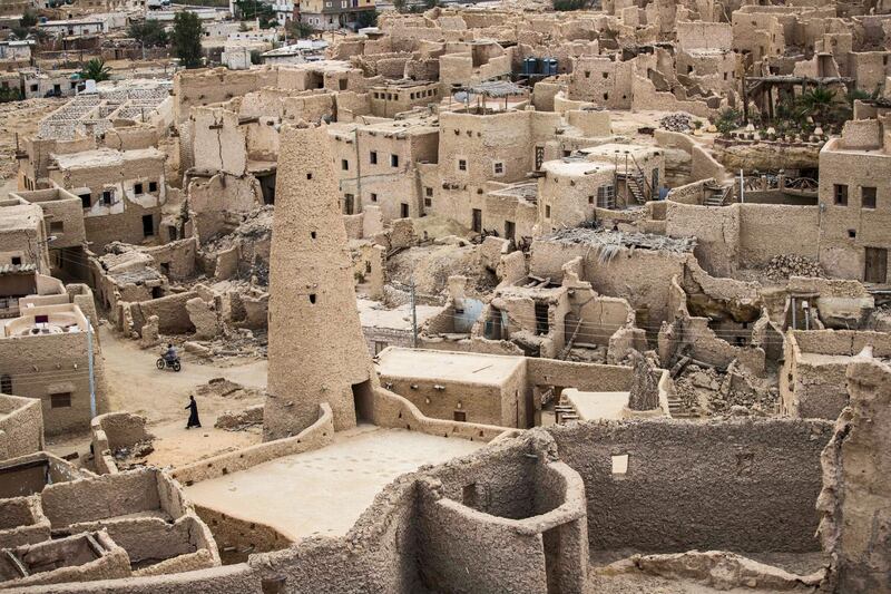 This picture shows a view of the recently restored fortress of Shali and its surroundings, in the Egyptian desert oasis of Siwa, some 600 kms southwest of the capital Cairo, on November 6, 2020. - The 13th century edifice, called Shali or "Home" in the Siwi language, was built by Berber populations, using kershef, a mixture of clay, salt and rock which acts as a natural insulator in an area where the summer heat can be scorching.
After it was worn away by erosion, and then torrential rains in 1926, the European Union and Egyptian company Environmental Quality International (EQI) from 2018 sought to restore the building, at a cost of over $600,000. (Photo by Khaled DESOUKI / AFP)