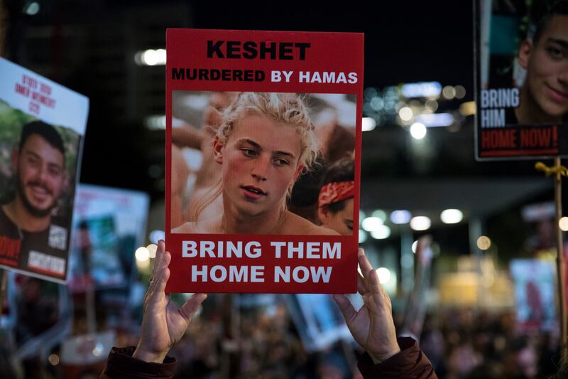 People hold signs and photos in Tel Aviv at a rally calling for the release of hostages held by Hamas in Gaza. Getty Images