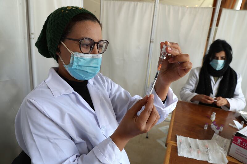 Medics prepare doses of the Pfizer-BioNTech vaccine during the booster campaign in Tunisia. EPA