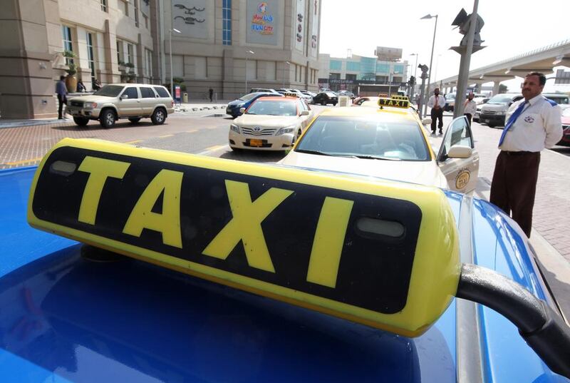 Taxi drivers are to be given Bluetooth headsets so they can make and take phone calls safely while they are driving. Pawan Singh / The National

