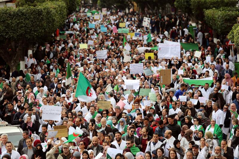 FILE PHOTO: Health workers carry national flags and banners as they march during a protest calling on President Abdelaziz Bouteflika to quit, in Algiers, Algeria March 19, 2019. REUTERS/Ramzi Boudina/File Photo