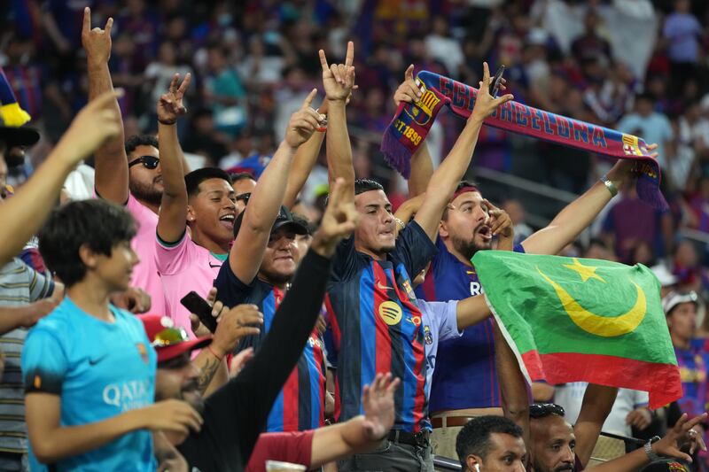 Barcelona fans cheer on their team during the pre-season game against Real Madrid. EPA