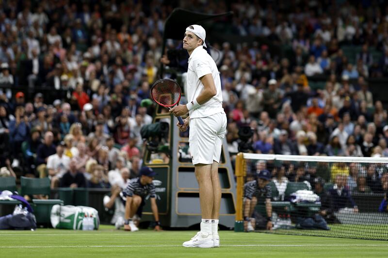 USA's John Isner celebrates victory against Great Britain's Andy Murray on Centre Court. PA
