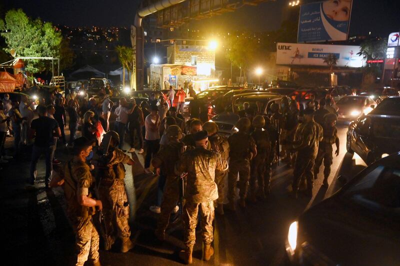 Lebanese army soldiers intervene as anti-government protesters attempt to block the main highway during a protest to demand a change of the sectarian system and finding solutions to the daily-living and economic crisis in Jal El Dib area north of in Beirut.  EPA