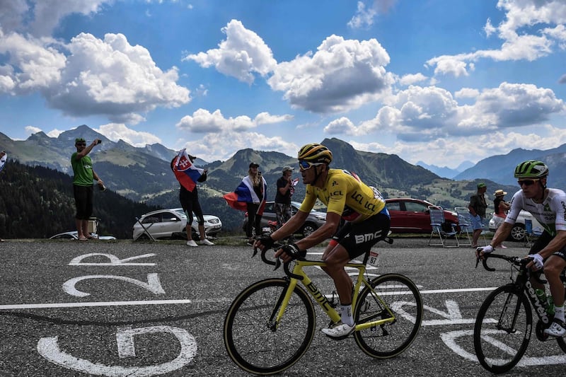 Belgium's Greg van Avermaet, centre, wearing the overall leader's yellow jersey, and Belgium's Serge Pauwels ride during the 10th stage of the Tour de France between Annecy and Le Grand-Bornand. Jeff Pachoud / AFP