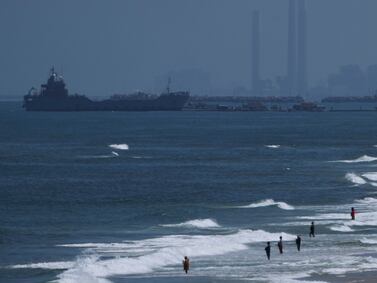 A ship is seen off the coast of Gaza near a U. S. -built floating pier that will be used to facilitate aid deliveries, as seen from the central Gaza Strip, Thursday, May 16, 2024.  (AP Photo / Abdel Kareem Hana)