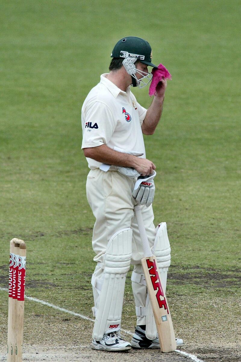 Retiring Australian Cricket captain Steve Waugh wipes the sweat from his brow with his charmed red handkerchief on the final day of the fourth test at the Sydney Cricket Ground 06 January 2004. Waugh made a respectable 80 runs andn India retained  Trophy after the two countries drew the series 1-1 . AFP PHOTO/David HANCOCK (Photo by DAVID HANCOCK / AFP)