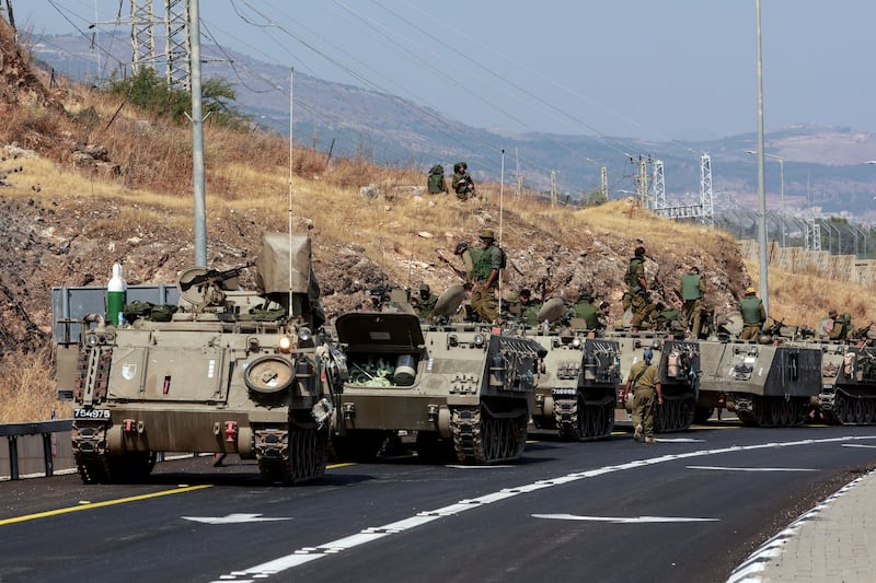 A convoy of Israeli Armoured Personnel Carriers drives near Israel's border with Lebanon, northern Israel, October 9. Reuters