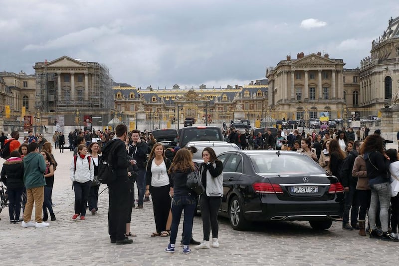 Fans gather to watch guests arriving in cars at the Chateau of Versailles to attend a private party hosted by Kim Kardashian and Kanye West on May 23, 2014 in Versailles, outside Paris. Kanye West and his fiancee Kim Kardashian head to Florence on May 24 to host a private party that might or might not be their wedding. Thomas Samson / AFP photo