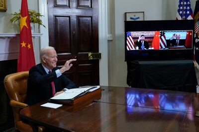 US President Joe Biden waves as he meets virtually with Chinese President Xi Jinping in November. AP Photo