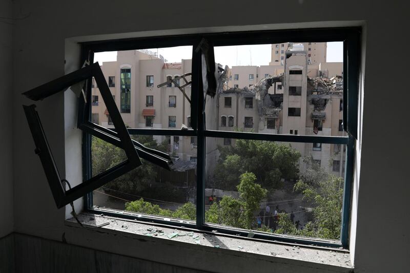 An apartment block is seen through a damaged window. Reuters