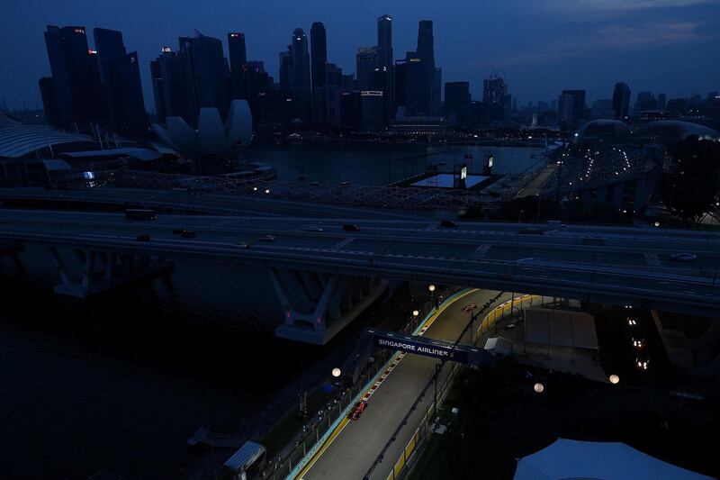 Cars compete during the qualifying session ahead of the Singapore Formula One Grand Prix at the Marina Bay Street Circuit. AFP
